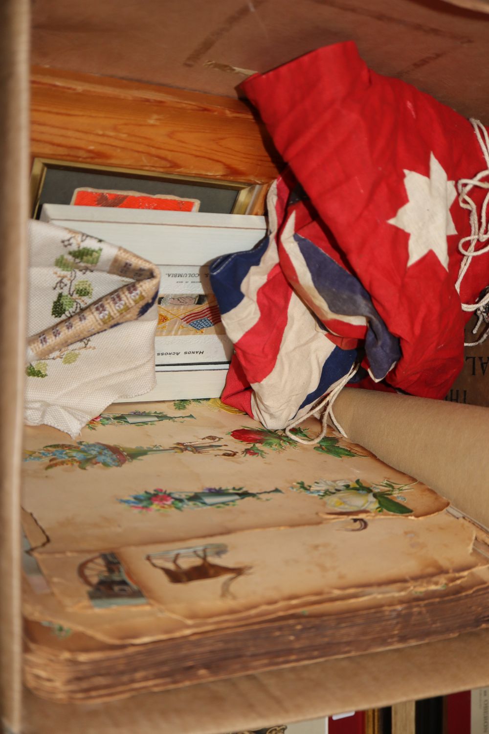 An Australian Naval ensign, a Union Jack stevengraph, a scrap book, a painted panel, a book The Social Ladder by C.D. Gibson, etc (9)